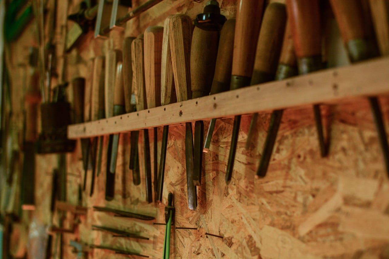 Home A collection of chisels and wood carving tools organized in a workshop setting.
